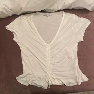 Ruffled, white short sleeve. V neck - size small.